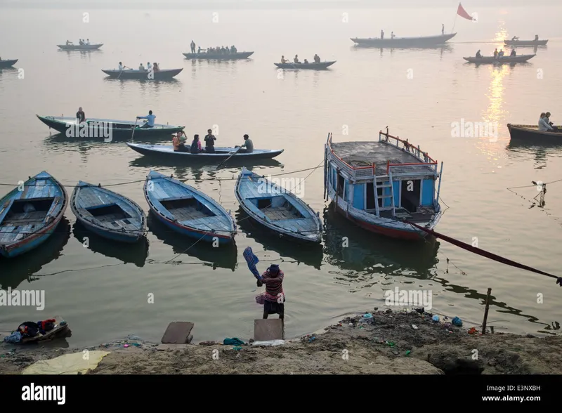 Image Varanasi - Ghats of the Ganges image beautiful image beautiful - Man washing clothes and tourist boats at beautiful sunrise early ...